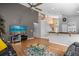 Open living room with hardwood floors and a view into the kitchen at 2570 Amaya Ter, Lake Mary, FL 32746