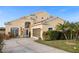 Two-story house with a beige exterior, landscaped yard, and a two-car garage at 2570 Amaya Ter, Lake Mary, FL 32746