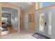 Entryway with tile floors, a view into the living room, and a stained glass door at 2570 Amaya Ter, Lake Mary, FL 32746