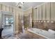 Spa-like bathroom features a soaking tub, glass shower, and marble finishes at 421 Lakewood Dr, Winter Park, FL 32789