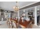 Formal dining room with a large table, chandelier, and access to the living room at 421 Lakewood Dr, Winter Park, FL 32789