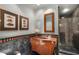 Small bathroom with dark marble and a walk-in shower at 421 Lakewood Dr, Winter Park, FL 32789