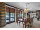 Bright dining room with water views, a large table, and striped curtains at 421 Lakewood Dr, Winter Park, FL 32789