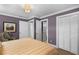 Spacious bedroom with plush bedding, built-in closet, and a sitting area at 421 Lakewood Dr, Winter Park, FL 32789