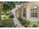 House exterior featuring a walkway and lush landscaping at 11511 Sw 72Nd Cir, Ocala, FL 34476