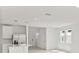 Open floor plan with kitchen island, stainless steel appliances and light flooring at 5953 Catamaran Ave, Haines City, FL 33844