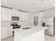 Modern kitchen with white cabinets, quartz countertops, and stainless steel appliances at 5953 Catamaran Ave, Haines City, FL 33844