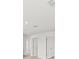 Bright hallway with doors to bedrooms and carpet flooring at 5953 Catamaran Ave, Haines City, FL 33844