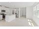 Modern kitchen with white cabinets, island, and stainless steel appliances at 5953 Catamaran Ave, Haines City, FL 33844