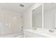 Bathroom with shower, double vanity, and white tile at 5953 Catamaran Ave, Haines City, FL 33844
