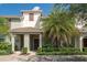 Two-story light-grey townhouse with dark brown door at 4803 Brier Rose Ln, Kissimmee, FL 34746