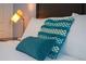 Cozy bedroom with teal pillows and bedside lamp at 4803 Brier Rose Ln, Kissimmee, FL 34746