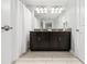 Double vanity bathroom with dark brown cabinets and granite countertop at 4803 Brier Rose Ln, Kissimmee, FL 34746
