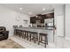Kitchen with breakfast bar, stainless steel appliances, and dark cabinets at 4803 Brier Rose Ln, Kissimmee, FL 34746