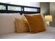 Bedroom with mustard yellow pillows on a bed at 4803 Brier Rose Ln, Kissimmee, FL 34746