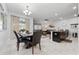 Bright dining area with a table for six and access to the living room at 4803 Brier Rose Ln, Kissimmee, FL 34746