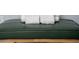 Stack of white towels on a dark green cushioned bench at 4803 Brier Rose Ln, Kissimmee, FL 34746