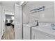Modern laundry room with washer, dryer, and shelving at 4803 Brier Rose Ln, Kissimmee, FL 34746