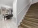 Modern staircase with wood-look treads and a simple handrail at 4803 Brier Rose Ln, Kissimmee, FL 34746