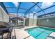 Private screened-in pool area with grill and lounge chairs at 4803 Brier Rose Ln, Kissimmee, FL 34746