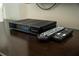 Technicolor cable box and two remotes on a table at 4803 Brier Rose Ln, Kissimmee, FL 34746
