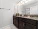 Bathroom with dark brown double vanity and granite countertop at 4803 Brier Rose Ln, Kissimmee, FL 34746