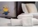 Close up of neatly folded white towels on a bed at 4803 Brier Rose Ln, Kissimmee, FL 34746