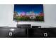 Flat screen TV above an entertainment center in a living room at 4803 Brier Rose Ln, Kissimmee, FL 34746