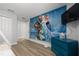 bedroom with Frozen mural and a dresser at 4803 Brier Rose Ln, Kissimmee, FL 34746
