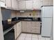 Small kitchen with light cabinets and granite countertops at 2860 N Powers Dr # 14, Orlando, FL 32818