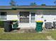 Backyard with patio, trash cans, and AC units at 241 N Hill Ave, Deland, FL 32724