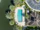 Aerial view of community pool and spa with surrounding landscaping and building at 4865 Cypress Woods Dr # 2204, Orlando, FL 32811