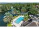 Community pool with palm trees and lounge chairs at 4865 Cypress Woods Dr # 2204, Orlando, FL 32811