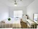 Well-lit bedroom with a queen bed, dresser, and workspace at 4865 Cypress Woods Dr # 2204, Orlando, FL 32811