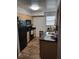 Galley kitchen with dark countertops and wooden cabinets at 3038 Antique Oaks Cir # 166, Winter Park, FL 32792