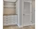 White cabinets and glass shelves in a storage area at 645 Marina Point Dr # 6450, Daytona Beach, FL 32114