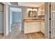 Vanity with granite countertop, updated cabinets, and view into bedroom at 645 Marina Point Dr # 6450, Daytona Beach, FL 32114