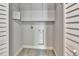Neat and clean laundry area with upper cabinets and tiled floor at 645 Marina Point Dr # 6450, Daytona Beach, FL 32114
