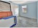 Light and airy bedroom with tile floors, large window, and sliding doors to balcony at 645 Marina Point Dr # 6450, Daytona Beach, FL 32114