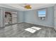 Bright bedroom with water views, ceiling fan, and tiled floors at 645 Marina Point Dr # 6450, Daytona Beach, FL 32114
