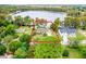 Aerial view of a house on a lake with lush landscaping at 16837 Arrowhead Blvd, Winter Garden, FL 34787