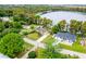 Aerial view of a house near a lake, surrounded by trees at 16837 Arrowhead Blvd, Winter Garden, FL 34787