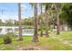 Serene lakeside backyard with string lights and a stone path at 16837 Arrowhead Blvd, Winter Garden, FL 34787