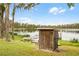 Wooden shed near the lake with dock and boat at 16837 Arrowhead Blvd, Winter Garden, FL 34787