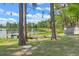 Charming lakeside yard with a dock and stone path at 16837 Arrowhead Blvd, Winter Garden, FL 34787