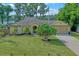 Single-story home with two car garage and mature tree at 16837 Arrowhead Blvd, Winter Garden, FL 34787