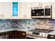 Stainless steel appliances and gray brick backsplash at 16837 Arrowhead Blvd, Winter Garden, FL 34787