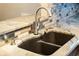 Double-basin sink with modern faucet and granite countertop at 16837 Arrowhead Blvd, Winter Garden, FL 34787