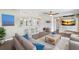Open-concept living room with kitchen bar and stone feature wall at 16837 Arrowhead Blvd, Winter Garden, FL 34787