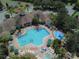 Relaxing community pool with surrounding lounge chairs and a splash pad at 2302 Silver Palm Dr # 301, Kissimmee, FL 34747